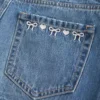 Düşük Bel Nakışlı Fiyonklu Denim Mini Etek